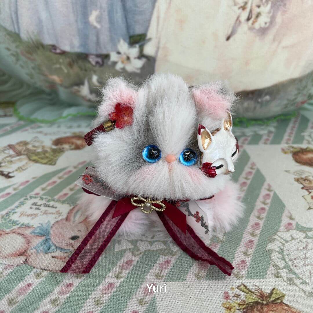 Handmade plush cosplay kitten with blue eyes, fox mask, and red bow. Perfect decoration for lovers of fantasy and fashion dolls.