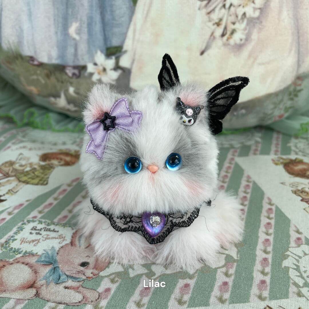Handmade plush kitten toy with butterfly wings, purple bow, and a lace collar. Part of the Cosplay Kitten Collection for fantasy lovers.