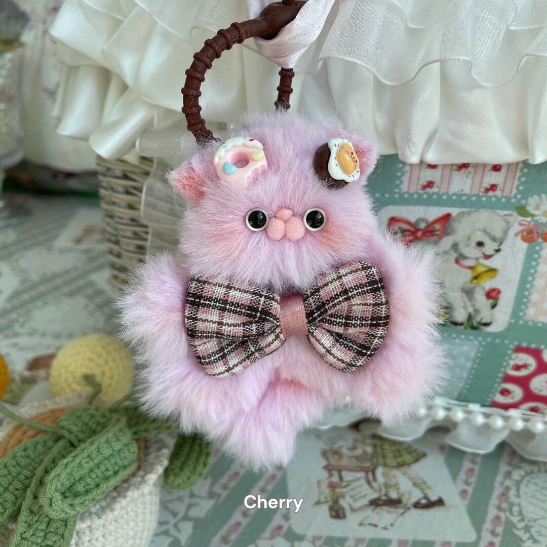 Adorable pink kitten pendant with plaid bow, crafted from soft faux fur for use as a charming bag charm or cute keychain accessory.