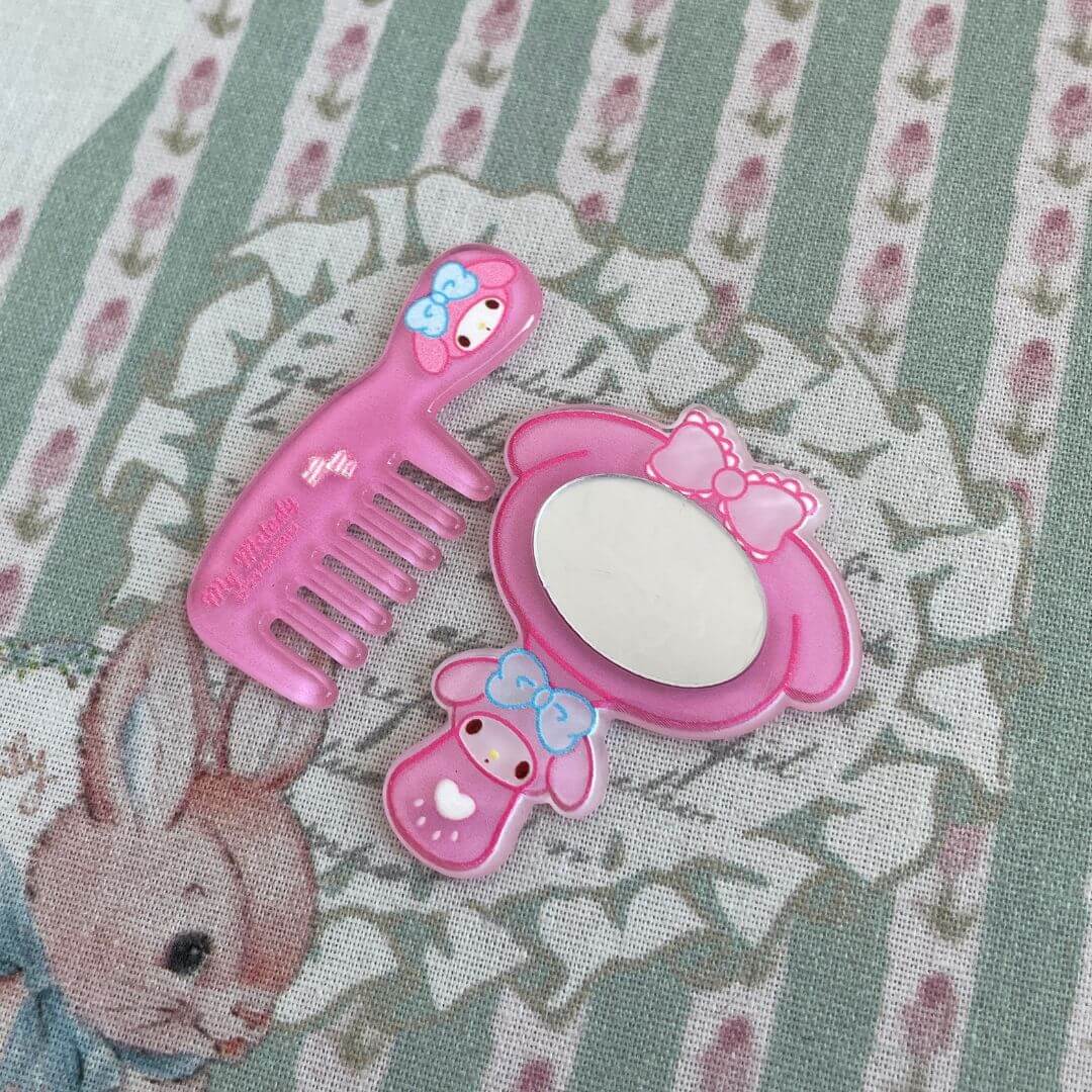 Adorable mini comb and mirror set in pastel pink with bow accents, ideal for kitten plush toy accessories or kawaii decor.
