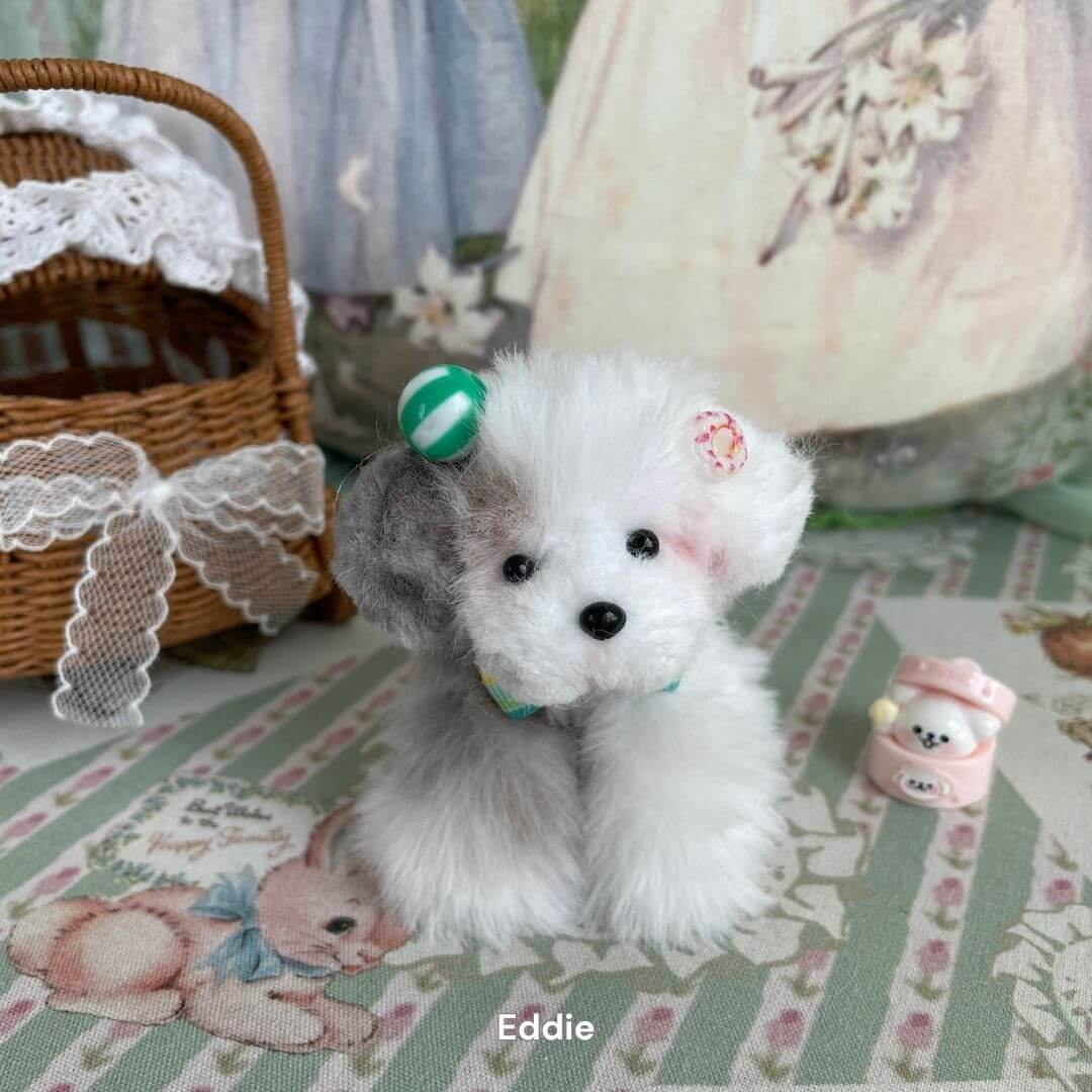 Handmade fluffy puppy plush toy named Eddie, with a cute face and decorative background. Part of the Adorable Puppy Collection.