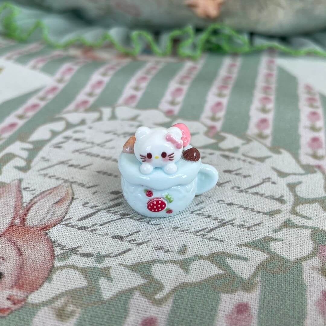 Adorable plush kitten toy in a decorated dessert cup, part of 'Cuppa Kitties' collection. Perfect for collectors and cat lovers.