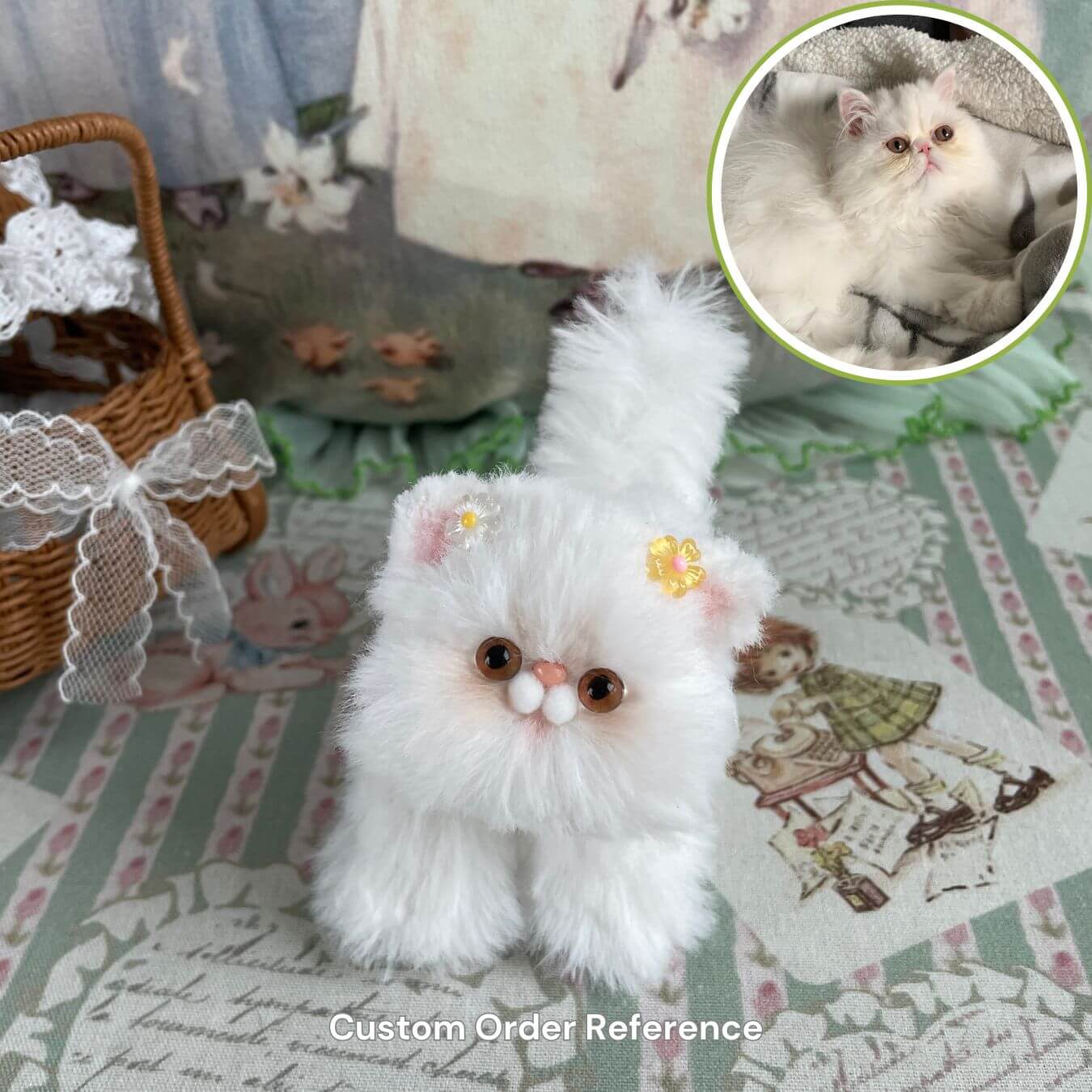Custom handmade fluffy white kitten plush next to a real cat for design reference, featuring decorative setting with basket and lace detailing.