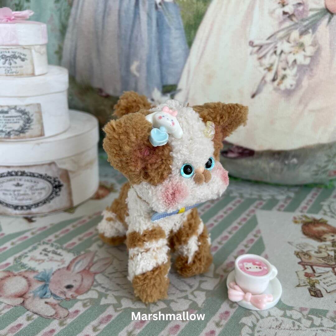 Handmade Devon Rex kitten plush toy in chocolate swirl design with a teacup accessory, featuring big blue eyes and quirky expression.