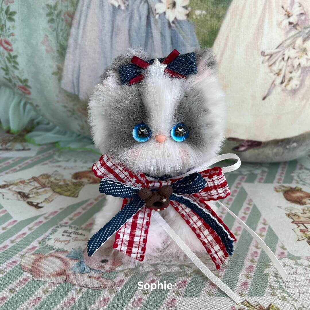 Handmade plush kitten toy with blue eyes and ribbons from Enchanted Big Paws Collection, perfect cat lover gift or decoration.