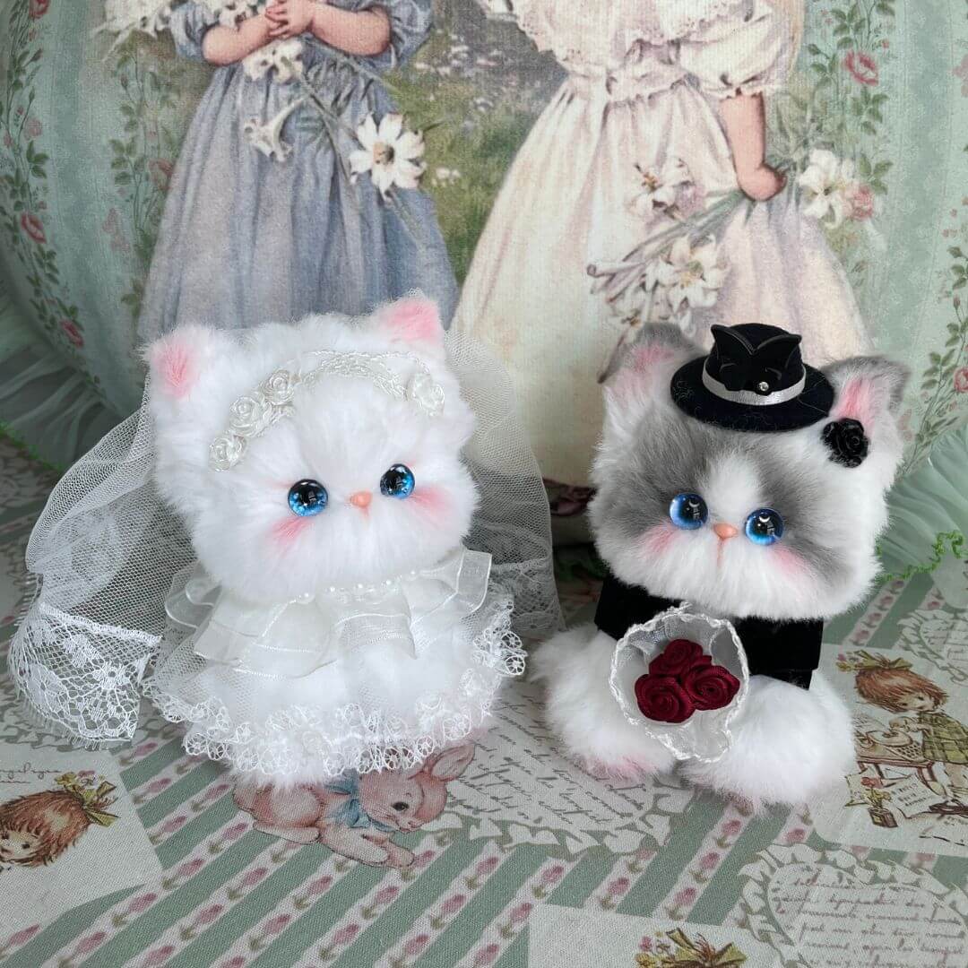 Handmade kitten figurines for the Enchanted Wedding of Mr. & Mrs. Paws, featuring a fluffy white bride and tuxedo cat groom.