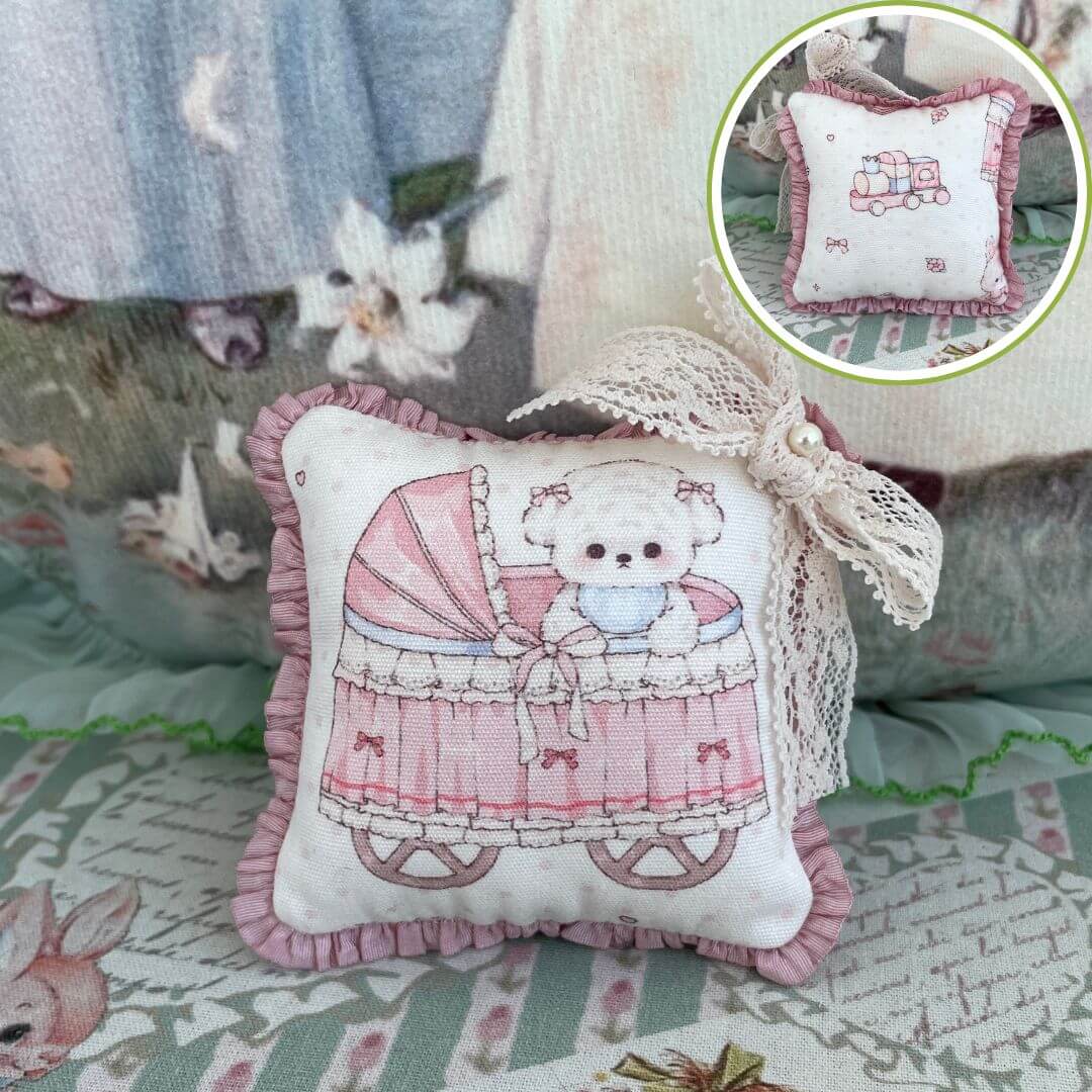 Handmade Mini Cuddle Critter Cushion with a pink stroller design and hand-stitched bow, perfect for dolls or as a decorative desk accessory.