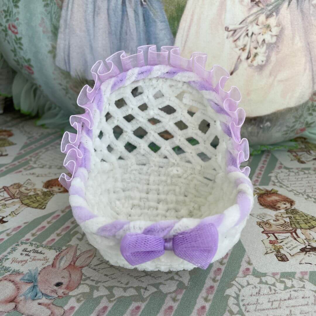 Handcrafted whimsical cradle with purple trim, perfect for dollhouses or as a decorative accessory for toy kittens and puppies.