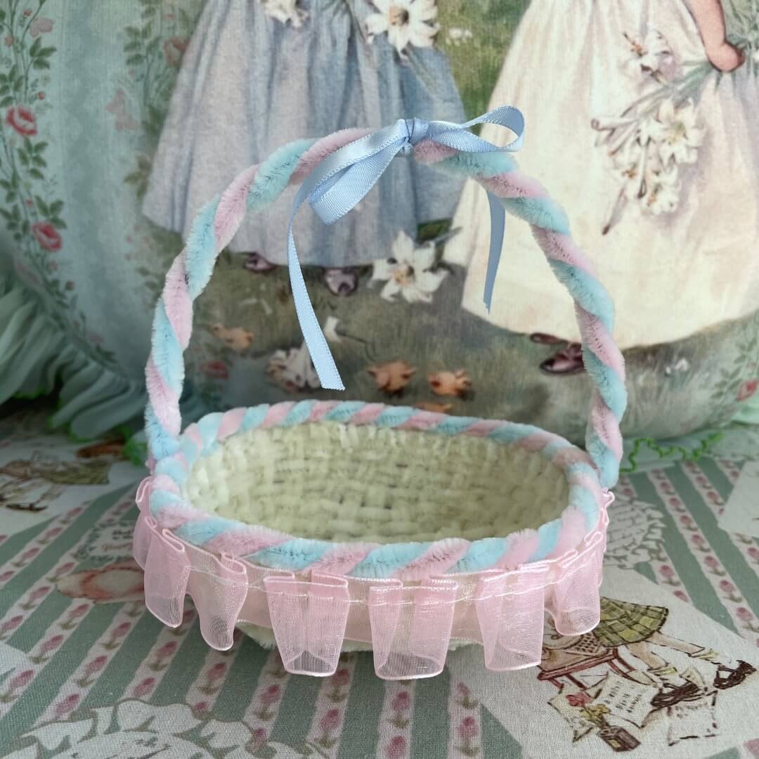 Handmade Whimsy Cradle basket with pastel ribbon, perfect for miniature pets or dollhouse decor.