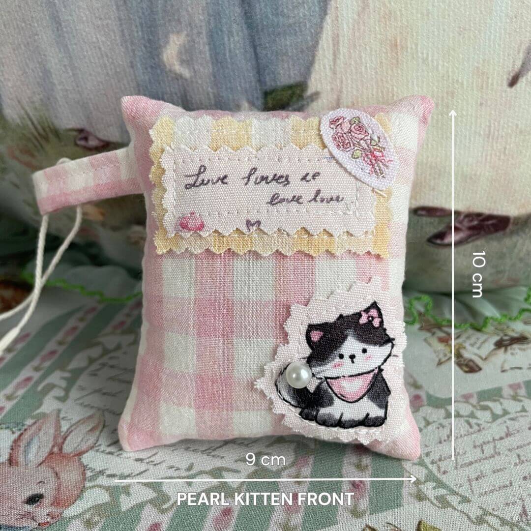 Mini handmade pillow bag charm with pink gingham and kitten design, perfect for small doll décor or handcrafted kitten homes.
