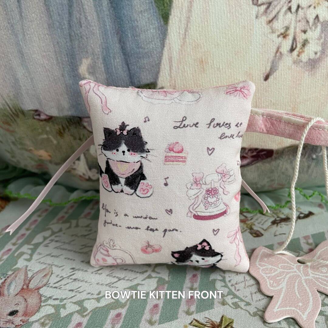 Mini handmade pillow bag charm with bowtie kitten design, ideal for dolls and handcrafted kitten homes. Cozy, high-quality accessory.