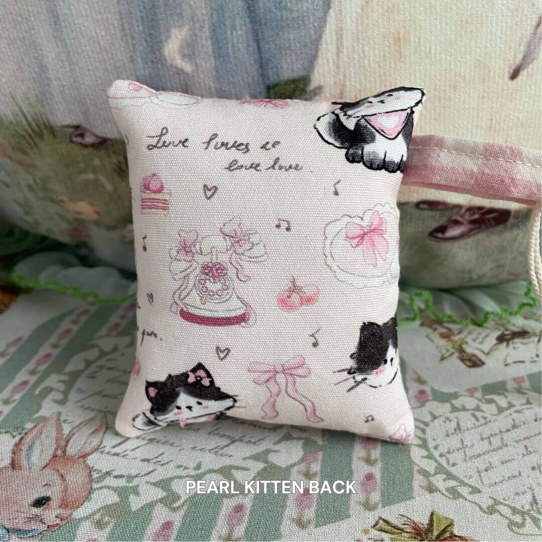 Mini handmade pillow with kitten and puppy design, perfect for bags or as décor for miniature homes. Features cute, plush animal motifs.