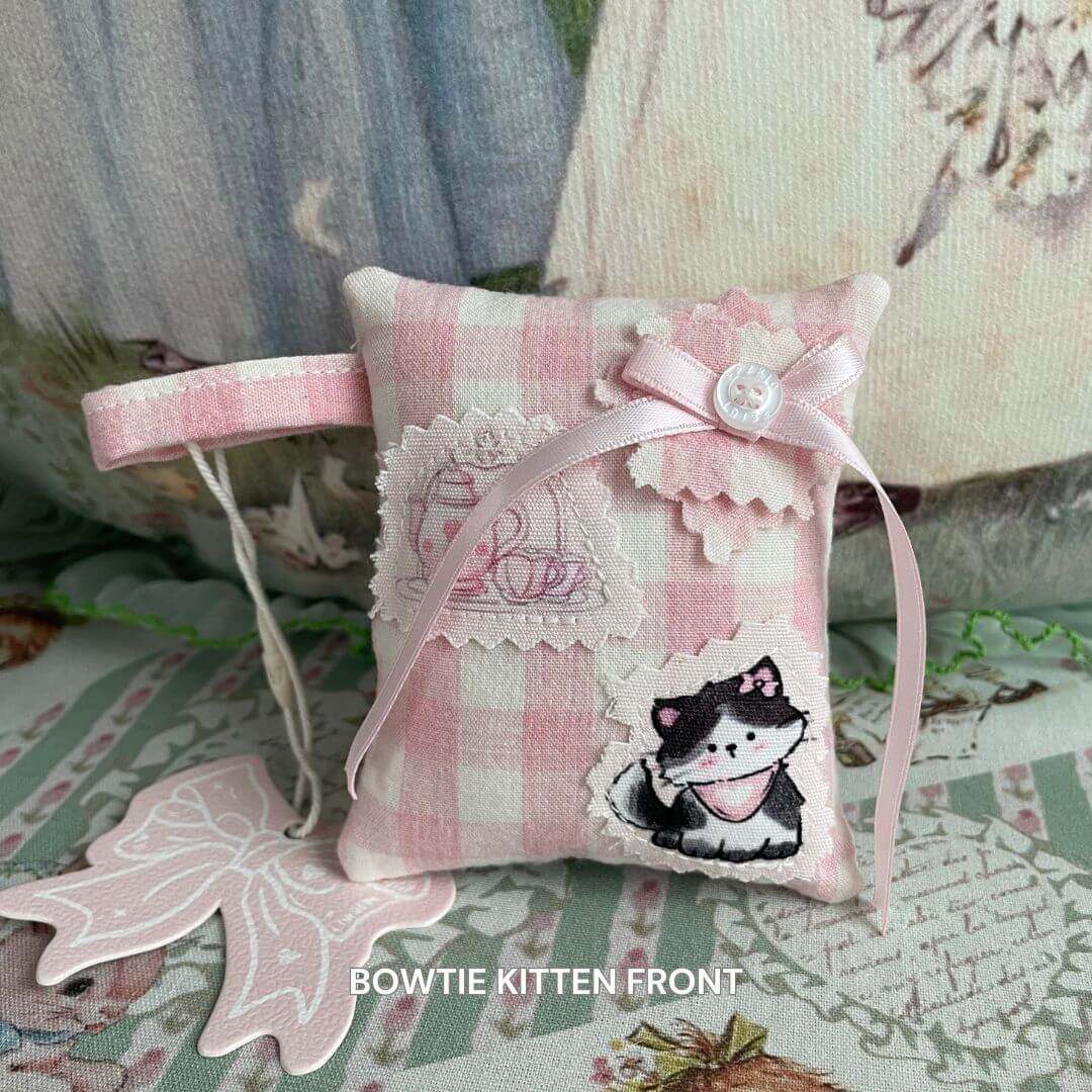 Mini handmade pillow with bowtie kitten design, check pattern, and loop for bag charm use, perfect for doll or kitten home decor.