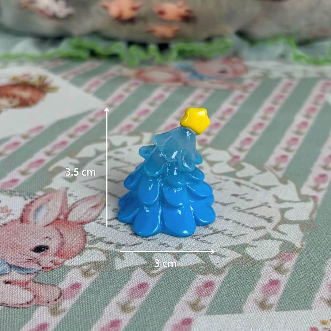 Miniature Christmas Accessories featuring a blue, hand-painted Christmas tree with a yellow star on top, perfect for Kawaii decor.