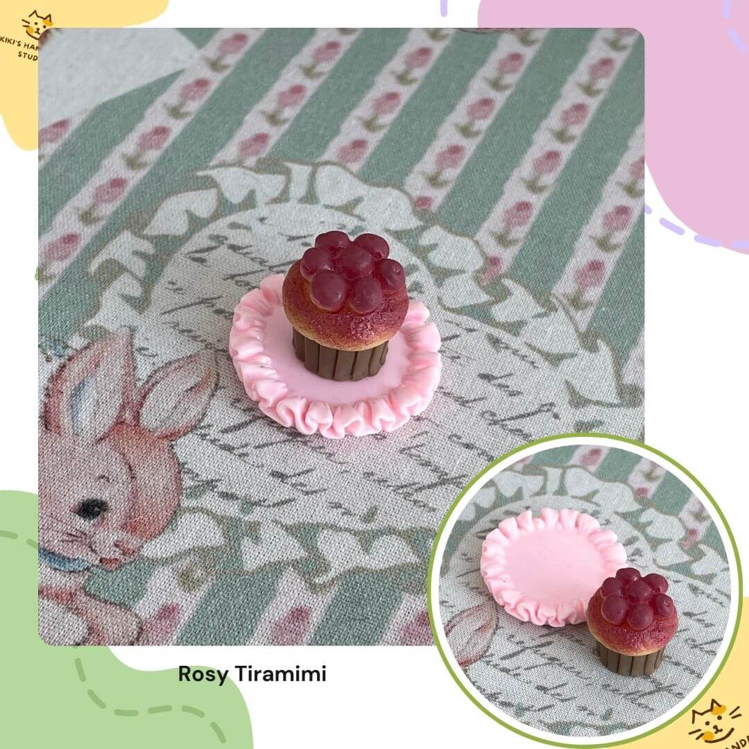Miniature cat-themed cupcake decor on a pink ruffled plate, perfect for dollhouse displays and cat lover's collections.