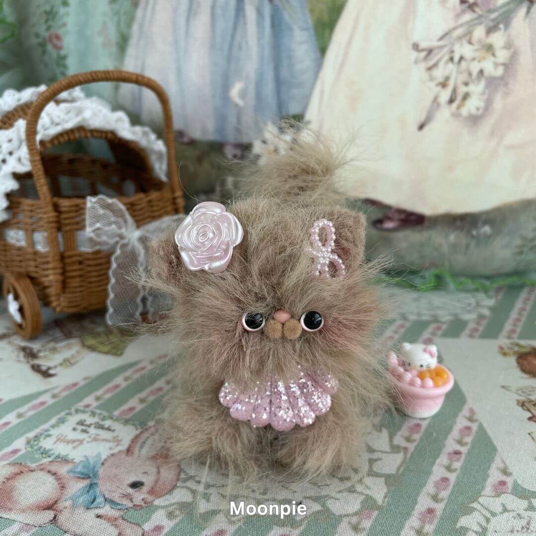 Handmade plush kitten with fluffy faux fur, pink decorations, and a whimsical style from the Siberian Snuggles Collection