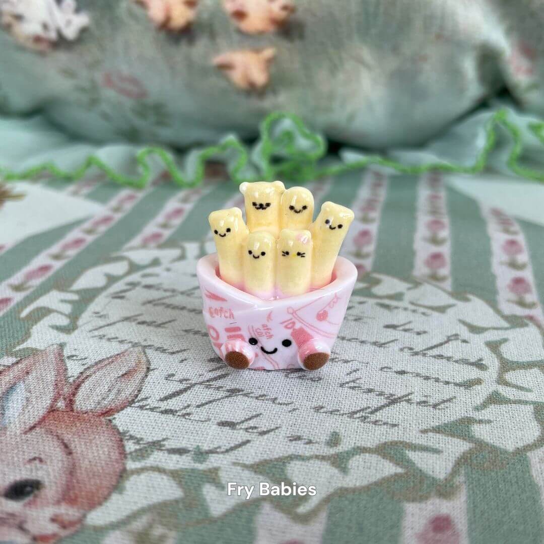 Kawaii Fry Babies: Smiling plush fries in a cute pink cup, perfect for decoration or gifting. Adds charm to any snackie collection.
