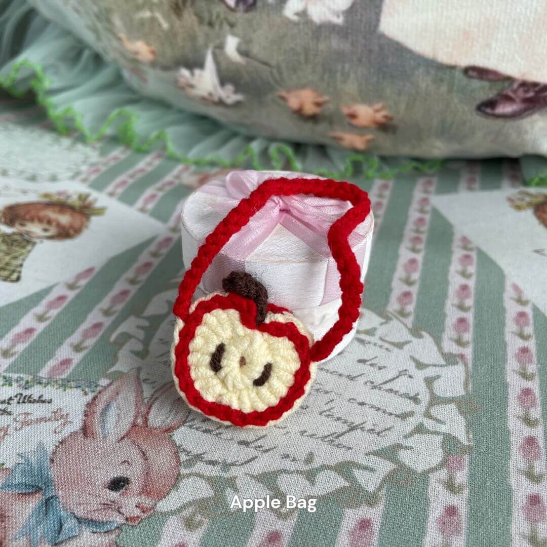 Handmade apple-shaped mini bag for plush toys, ideal for accessorizing small kittens or puppies with cute and charming style.
