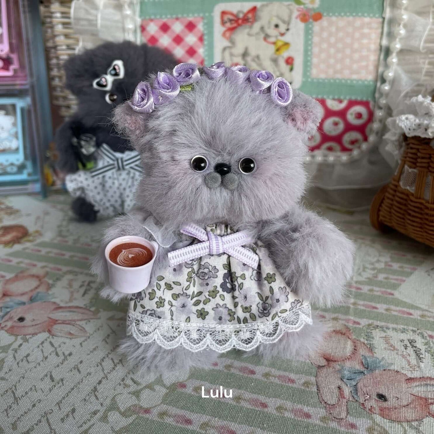 Cute handmade plush kitten with lilac flowers and tea cup, inspired by artist Kiki's cat Jelly. Perfect for decor or gift for cat lovers.