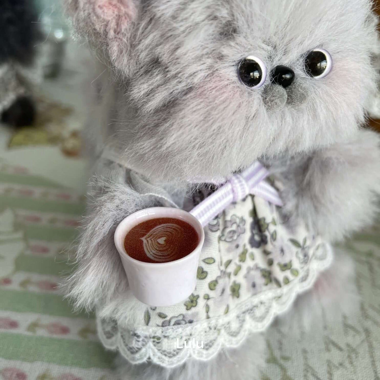 Handmade plush kitten toy from Tea Time Kitten Collection, wearing floral dress, holding a teacup. Perfect for cat lovers, home decoration.