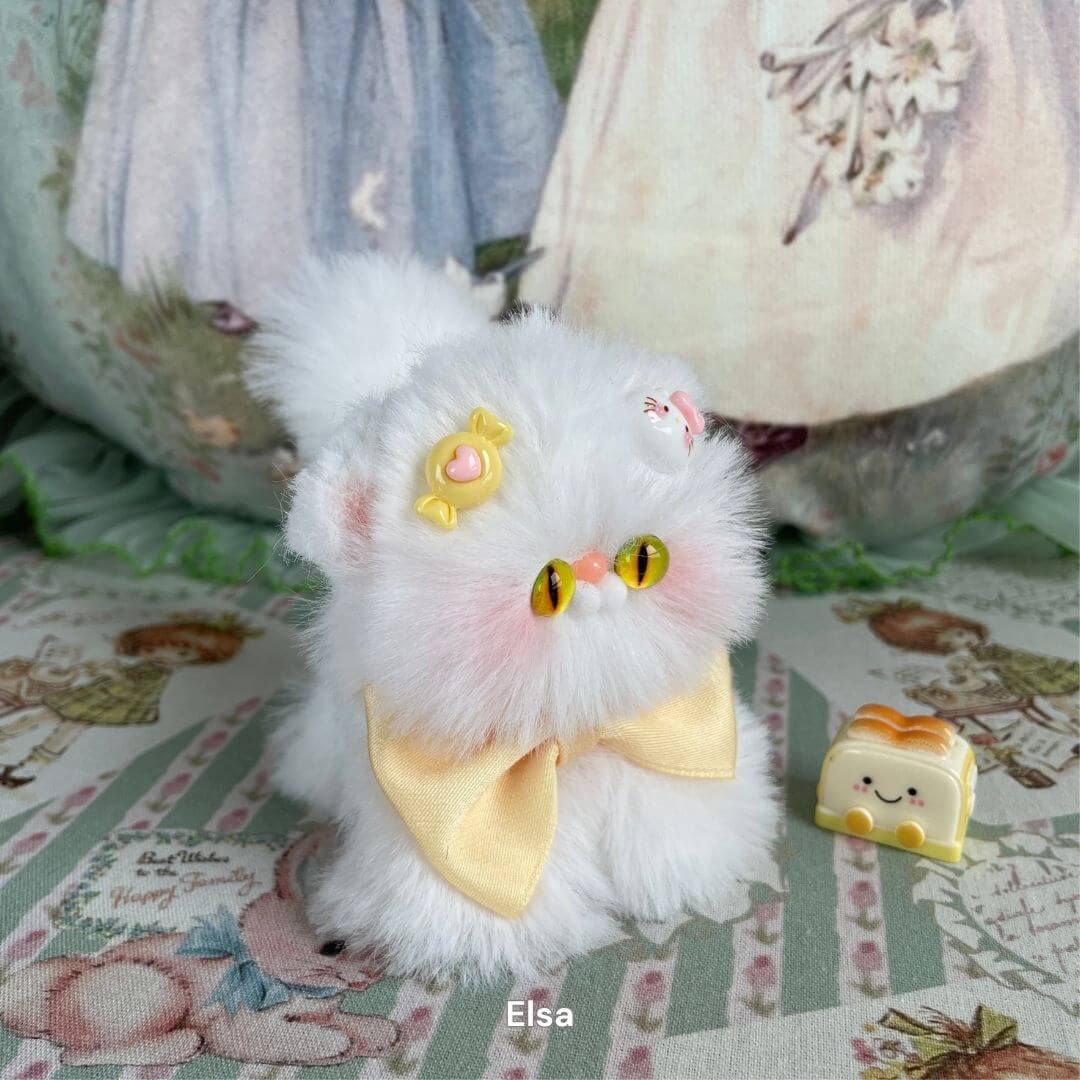 Handmade fluffy white kitten plush toy with yellow bow and candy decoration, part of the Fluffy Kitten Collection.