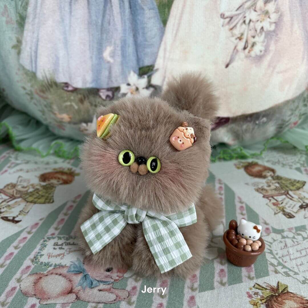 Handmade fluffy kitten plush toy with green bow, decorated with sweets on ears, part of the Fluffy Kitten Collection.