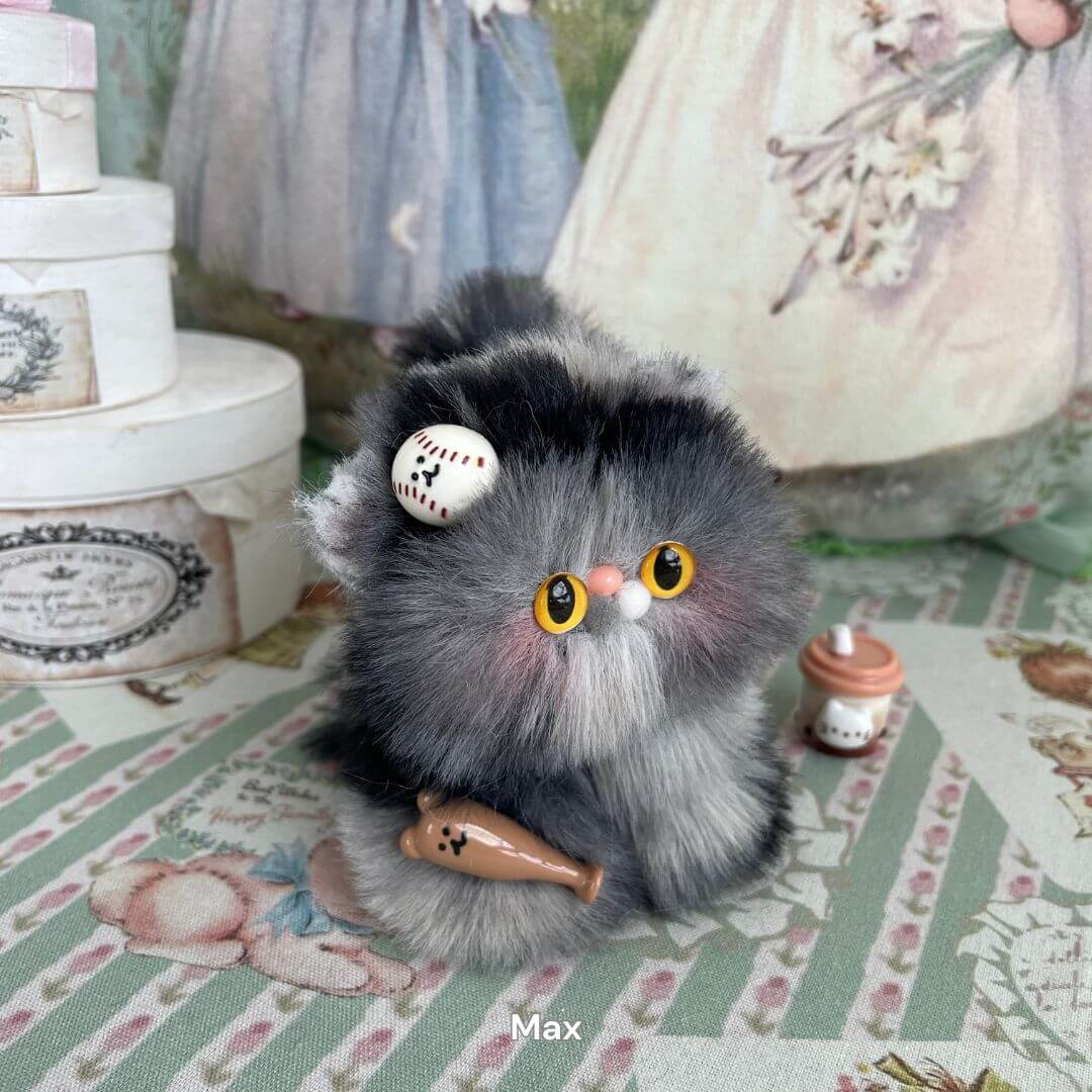 Handmade fluffy grey kitten plush toy with bright yellow eyes, decorated with cute accessories. Part of the Fluffy Kitten Collection.