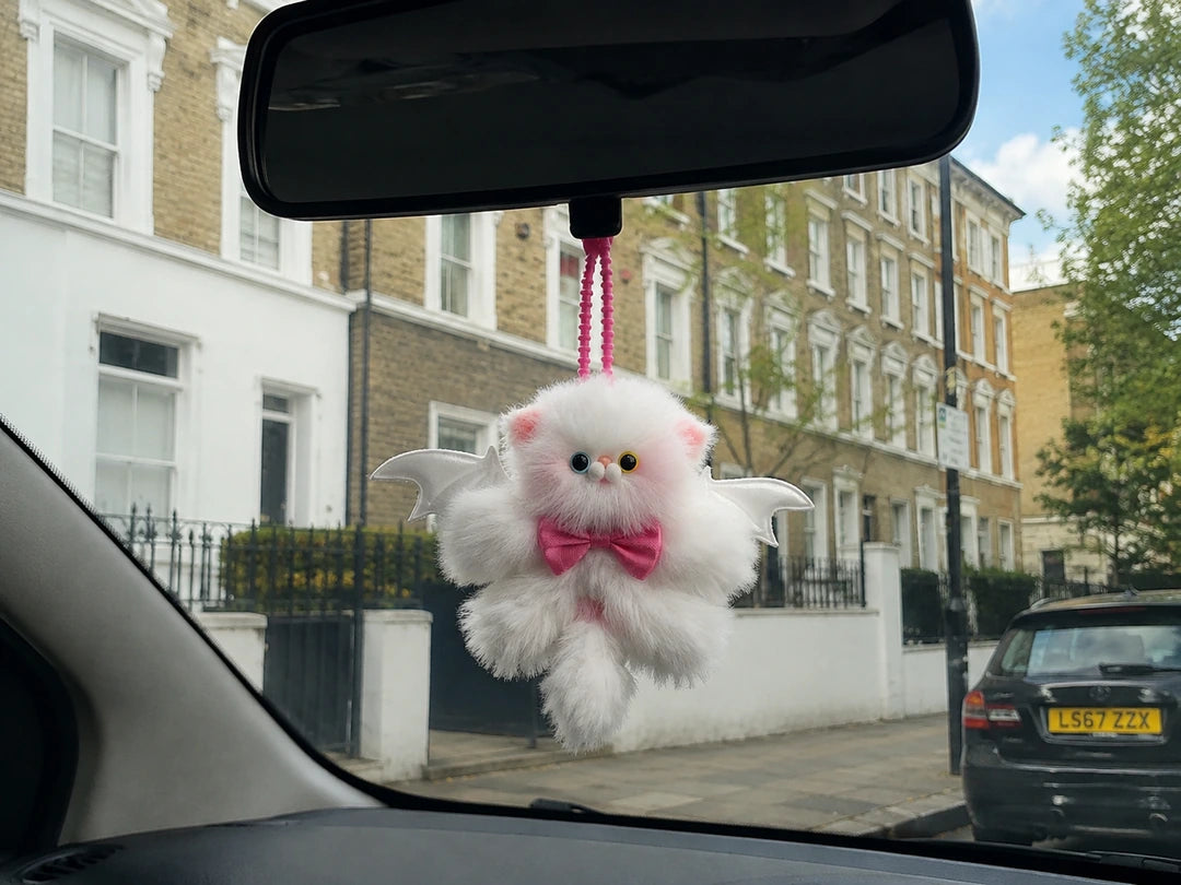 Handmade kitten companion displayed safely inside a car