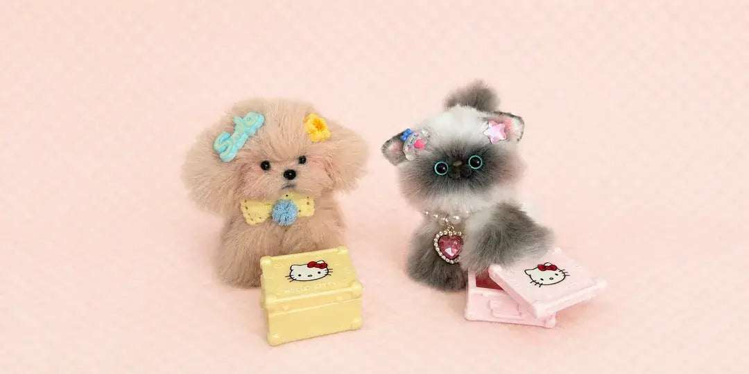 Two handmade fluffy kitten companions with a pink teacup on a soft blush background