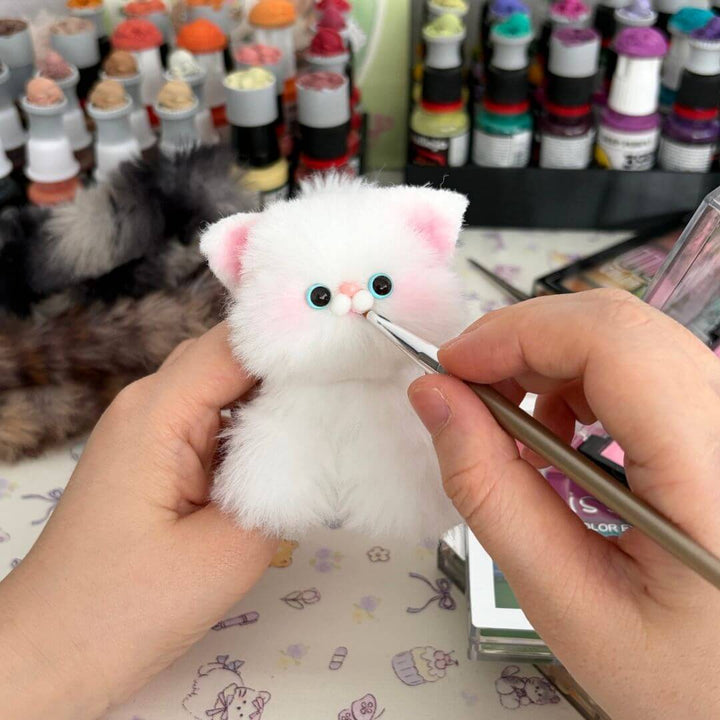 Hand painting details to a handmade companion