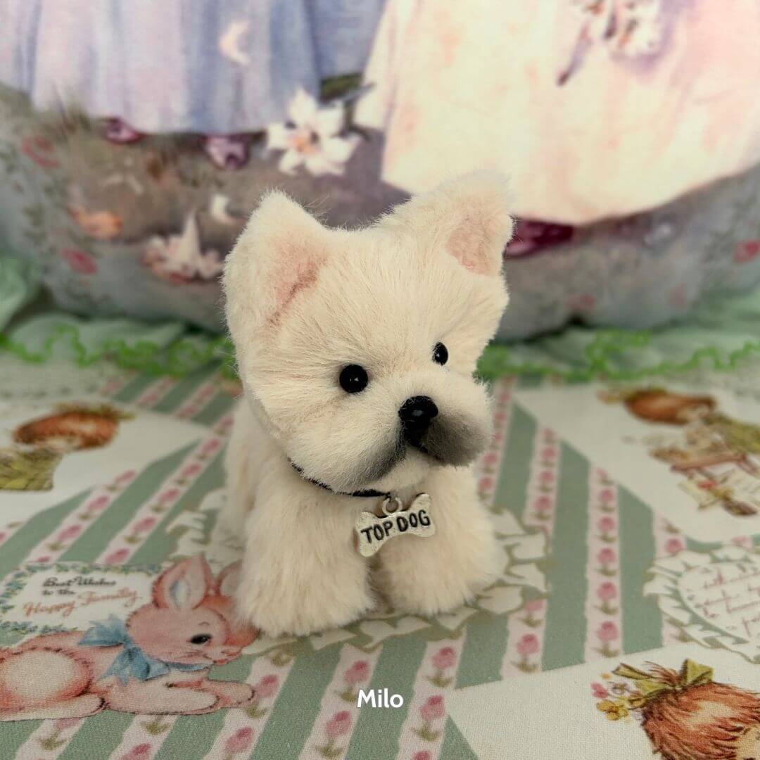 Adorable Puppy Collection featuring a fluffy white puppy named Milo with a 'Top Dog' tag, hand-sculpted, stylish decor.
