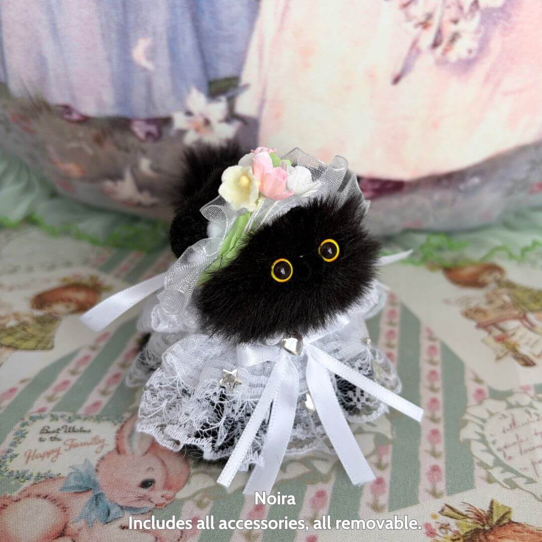 Handmade kitten from the Petals & Whispers Collection, black fluffy cat figurine in white lace with floral decorations.