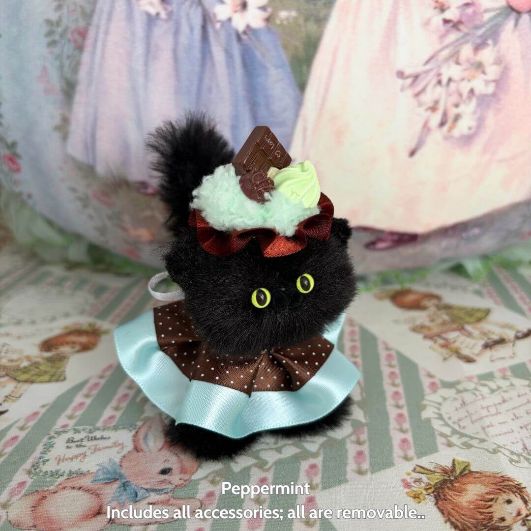 Alt tag for Sweet Treat Kitties: Adorable black handmade kitten with dessert hat, fluffy with a polka-dot bow, kawaii style.