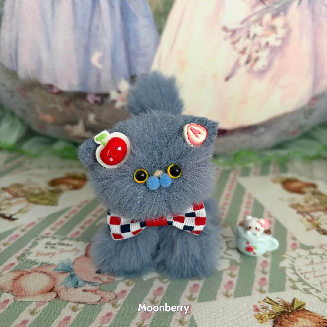 Alt Tag: Fruity Kitten Collection – cute grey handmade kitten wearing a cherry accessory and bowtie, fluffy cat figurine with expressive eyes.