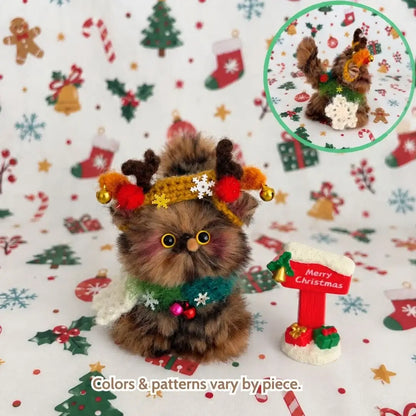 Brown tabby kitten wearing reindeer antlers.