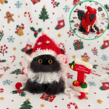 Black kitten dressed as Santa with a red hat and fluffy white beard.