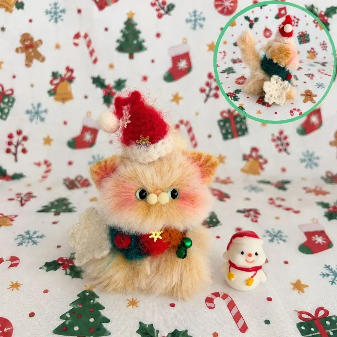 Ginger kitten wearing a red Santa hat and a festive scarf.