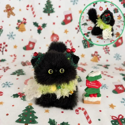 Black kitten with holly berries and a green festive collar.