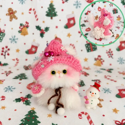 White kitten wearing a candy-pink festive hat.
