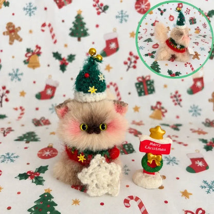Fluffy grey kitten with a green Christmas tree hat and snowflake.