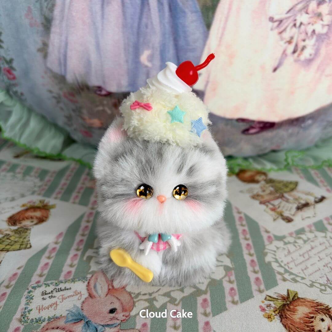 Handmade kitten from Mewlicious Collection, fluffy grey cat figurine with a cupcake hat, cute kawaii style, crafted in the UK.