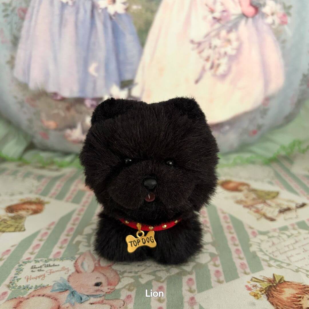 Lifelike Puppy Collection black fluffy dog figurine with 'TOP DOG' tag, cute expressions, on decorative patterned background.