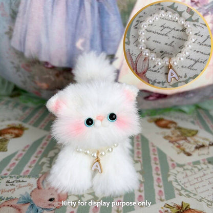 Cute fluffy kitten figurine wearing an Initial Pearl Necklace, showcasing a delicate A charm, perfect for display.