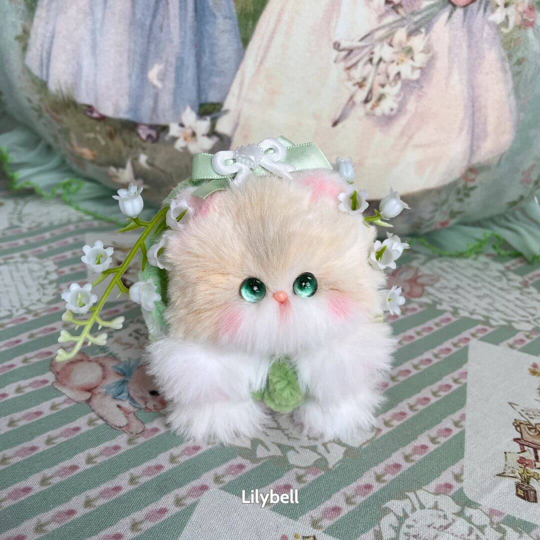 Blossom Kitten Collection: fluffy handmade kitten figurine with green eyes, pink accents, adorned with floral decorations and bows.