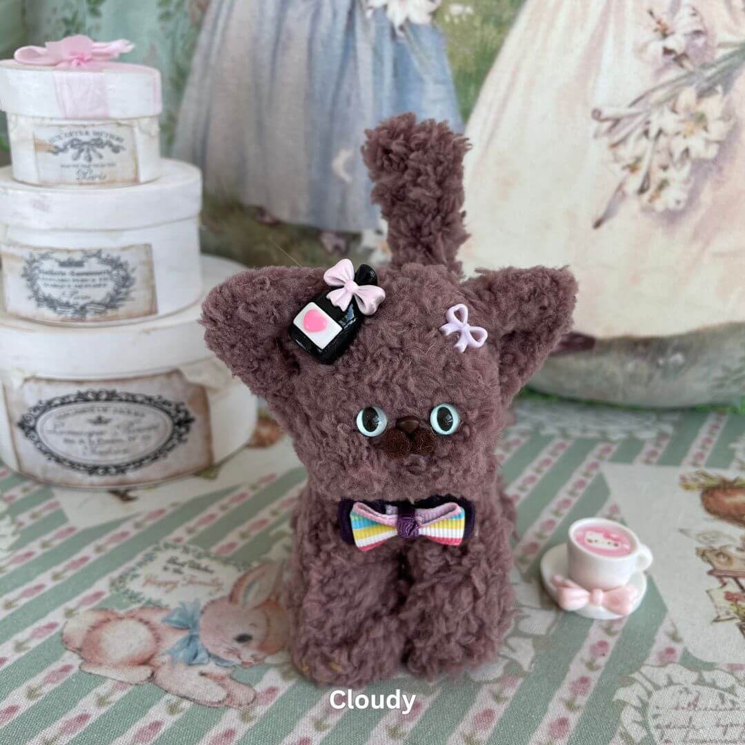 Handmade Devon Rex plush toy in brown faux fur with accessories, set in a vintage-style decor. Ideal for collectibles or decor.