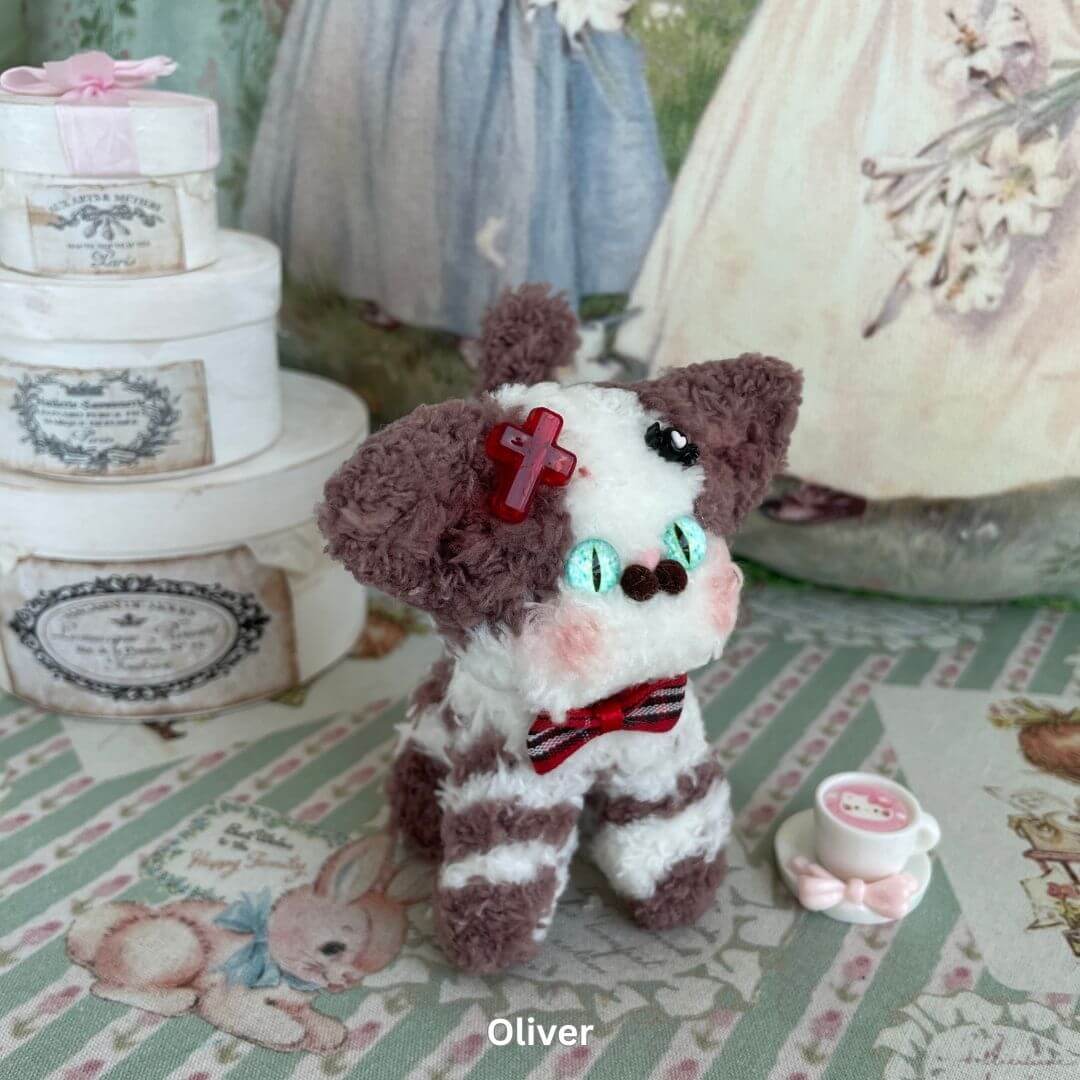 Handmade Devon Rex kitten plush toy with accessories, featuring a unique striped pattern, red bow, and faux fur texture.