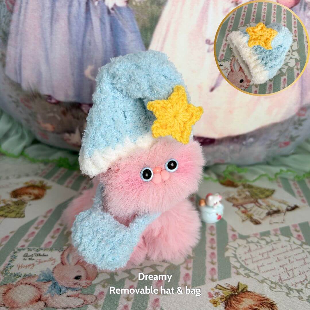 Fluffy Hoodie Kittens: Cute pink kitten figurine wearing a blue and yellow removable hat and bag, capturing a kawaii fantasy theme.