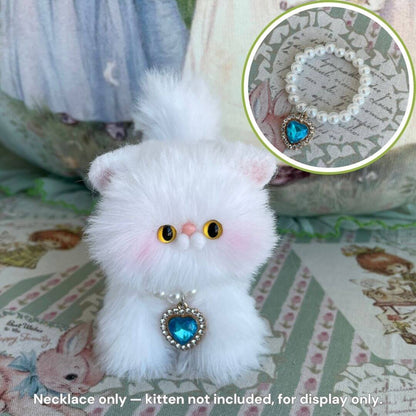 Elegant Heart Necklace on a fluffy kitten figurine, featuring a pearl-style chain and a heart-shaped turquoise pendant, perfect for collectibles.