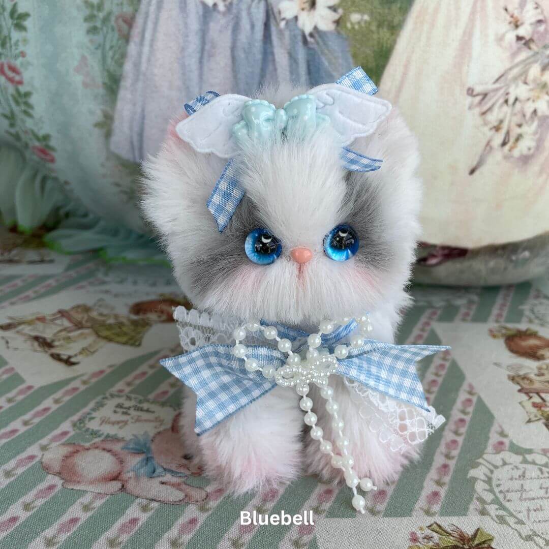 Handmade plush toy kitten with blue eyes and bow, part of the Enchanted Big Paws Collection, perfect cat lover gift or decor.