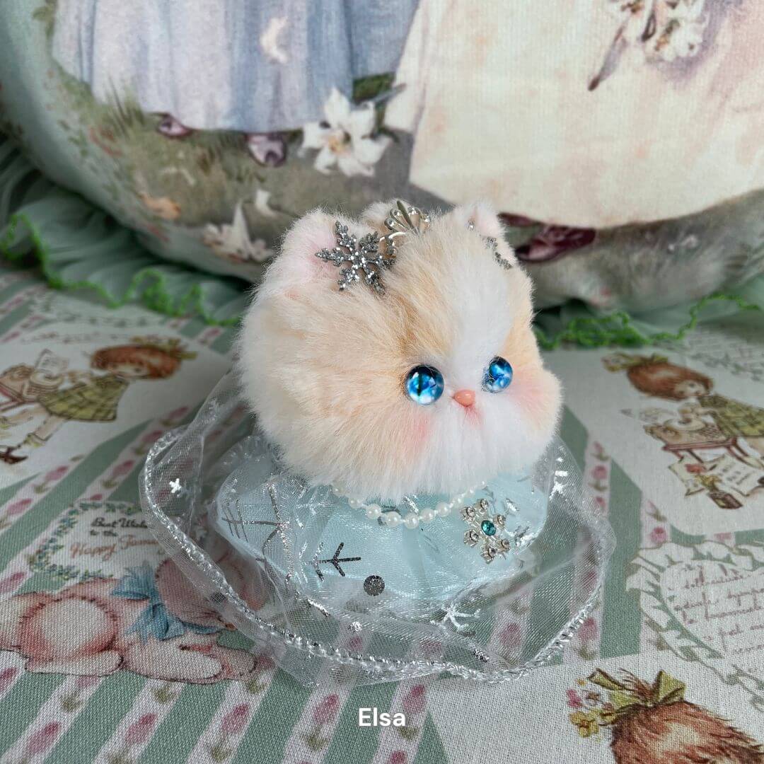 Handmade plush toy kitten with blue eyes and star crown from the Fairy Paws Collection. Perfect decoration for nursery or fairy tale theme.